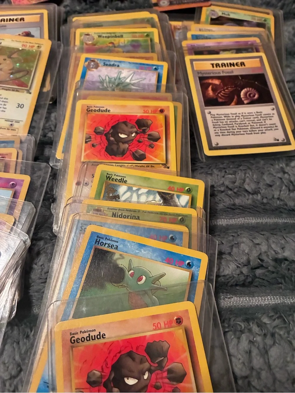 Pokemon Trading Card Lot - Assorted Colors 1997-98 trading cards in plastic hold